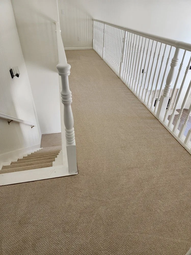 Beige textured carpet on a hallway landing and staircase by The Flooring Design Center, Campbell, CA