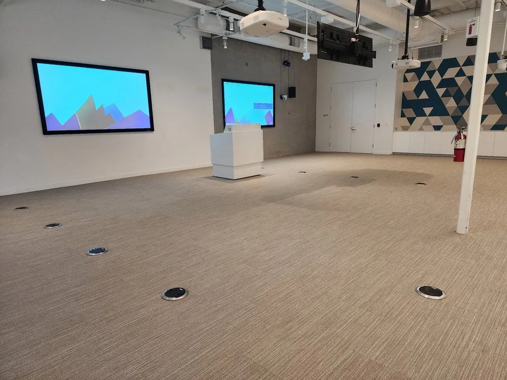 Commercial carpet tile installation in a modern conference room by The Flooring Design Center