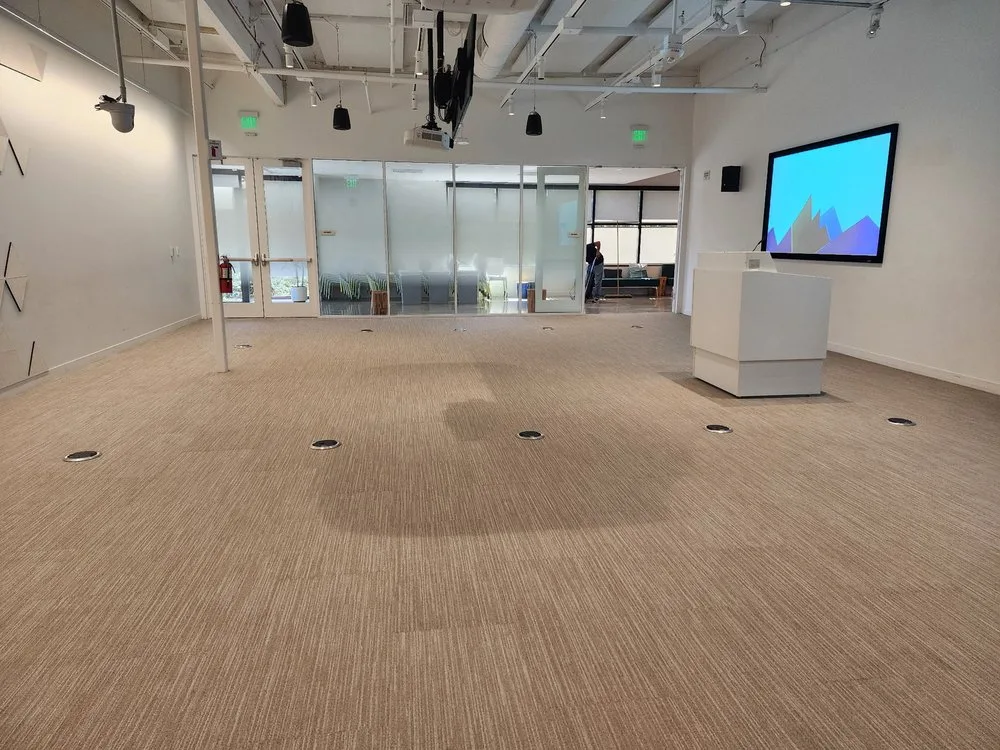 Large-scale commercial carpet installation in an office conference room by The Flooring Design Center
