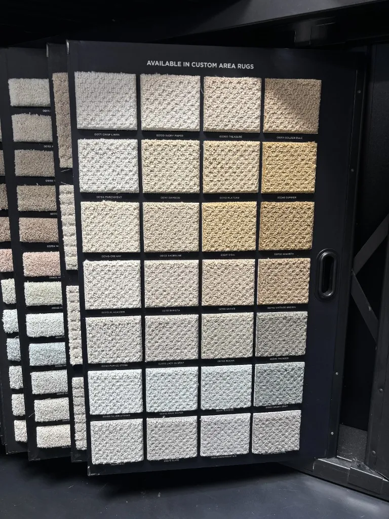 In-store carpet sample display with custom area rug options at The Flooring Design Center