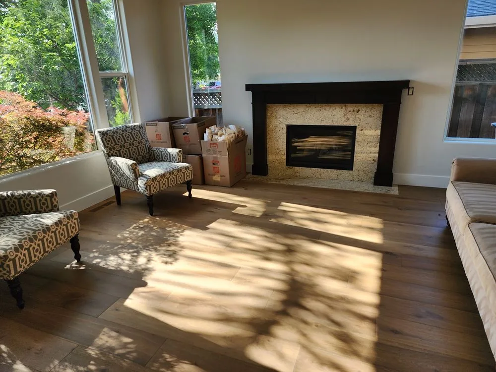Wide-plank luxury vinyl plank flooring in a sunlit living room by The Flooring Design Center, Campbell, CA